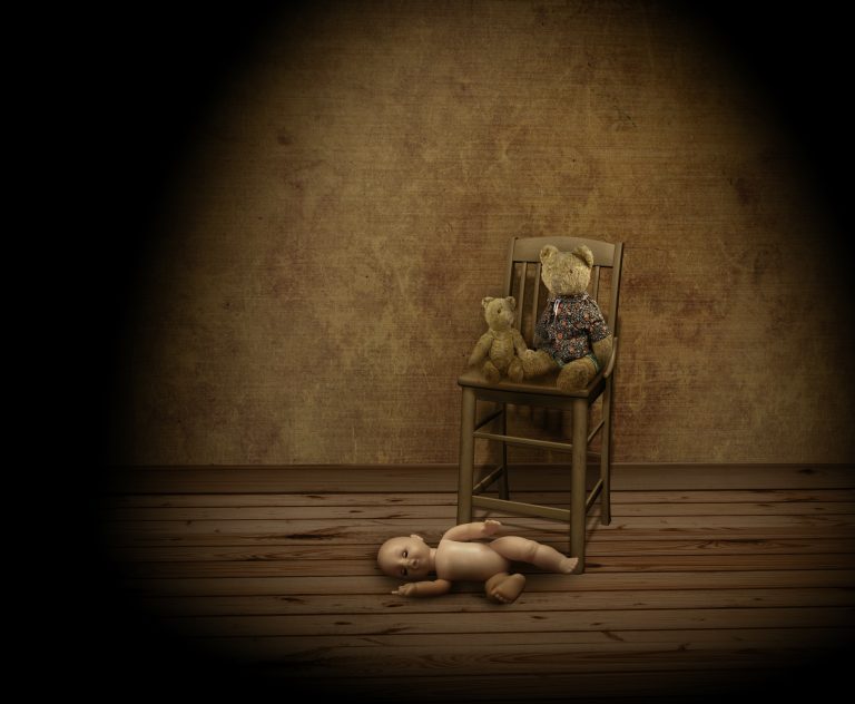 a teddy bear sitting on top of a wooden chair.