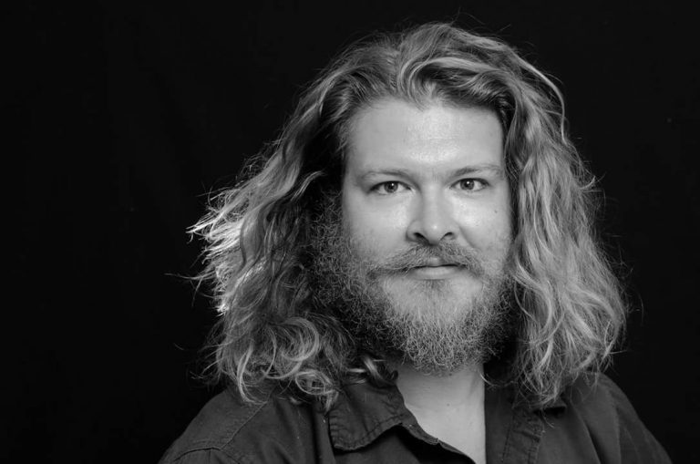 a man with long hair and a beard.