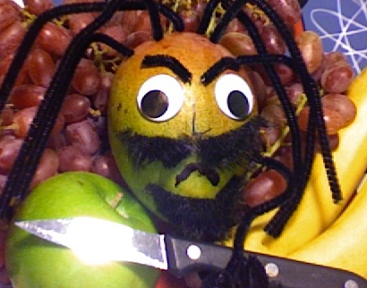 a close up of a fruit with a face on it.