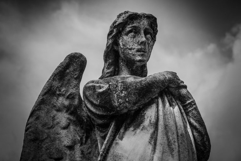 a black and white photo of an angel statue.