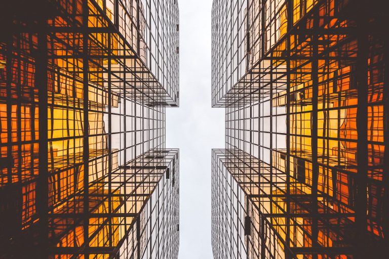 looking up at a group of tall buildings.