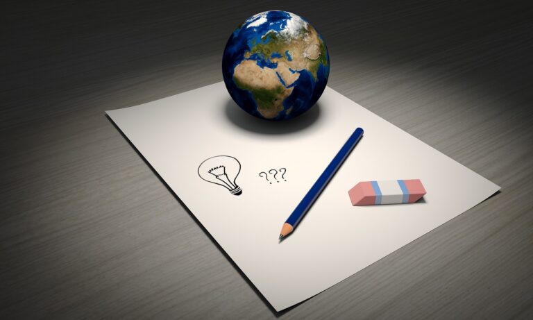 a pencil and eraser on top of a piece of paper.