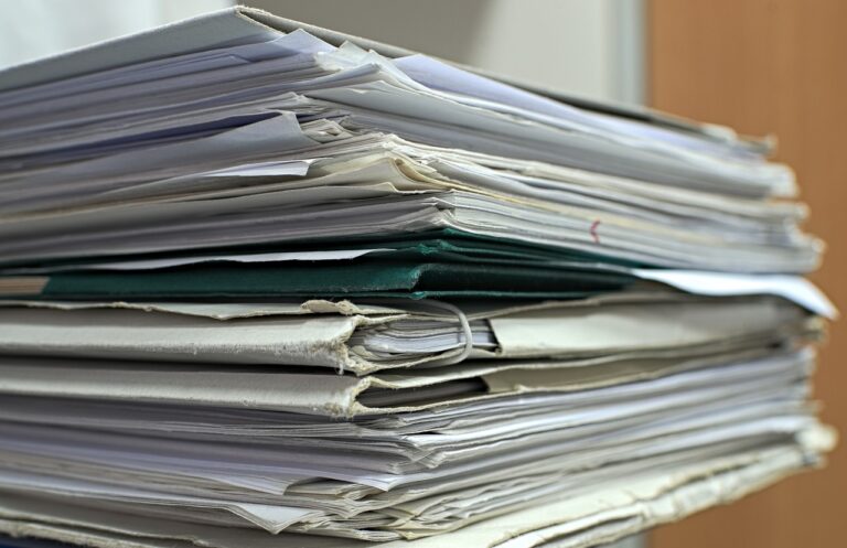 a stack of papers sitting on top of a table.