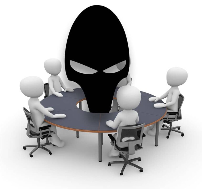 a group of people sitting around a round table.