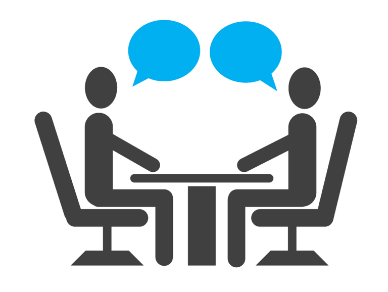 two people sitting at a table with speech bubbles above them.