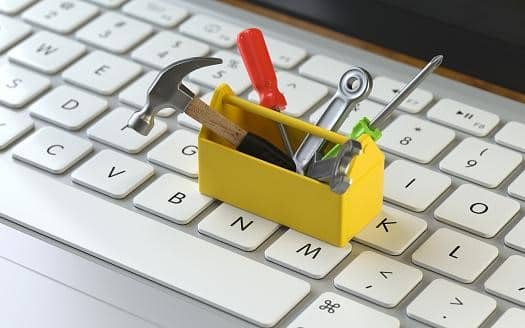 a miniature toolbox sitting on top of a keyboard.